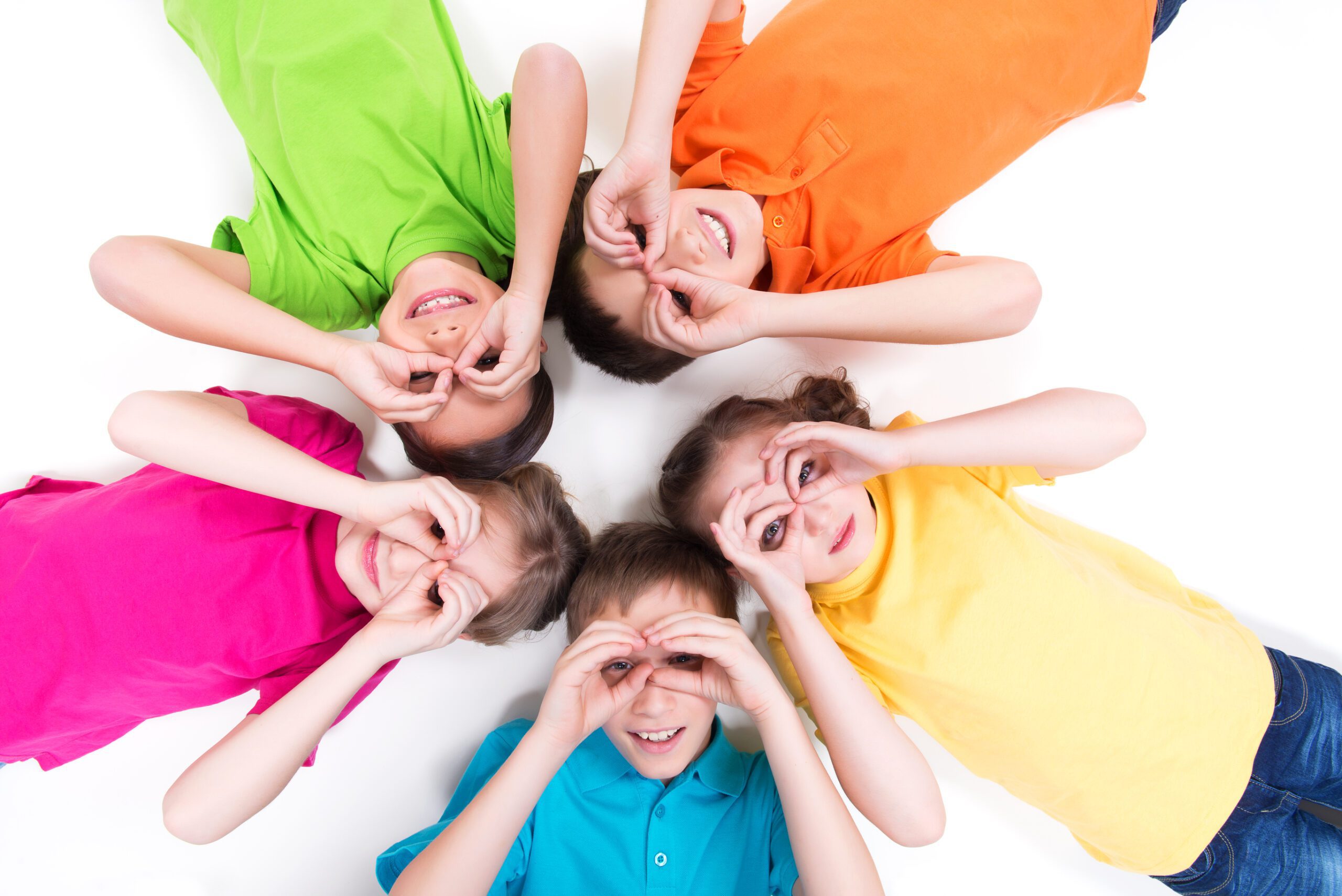 Group of Kids in Vibrant Shirts Creating a Circle With Their Hands