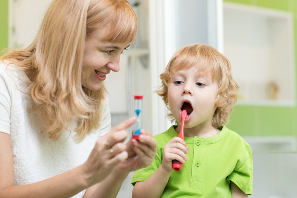 A Woman and Child Brushing Their Teeth Together, Promoting Good Oral Hygiene and a Healthy Lifestyle